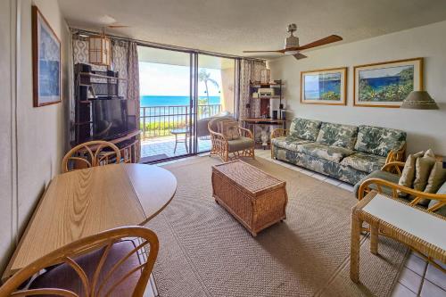 a living room with a couch and a table at New! Maalaea Banyans 204 - Expansive Ocean Views! in Wailuku