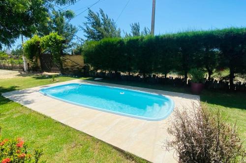 a small swimming pool in a yard with a yard at CasaMares Macapá - Praia de Macapá in Macapá