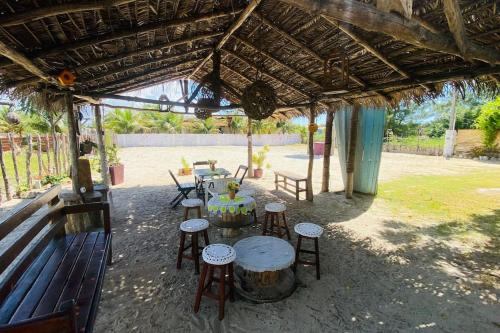 a group of tables and stools under a pavilion at CasaMares Macapá - Praia de Macapá in Macapá