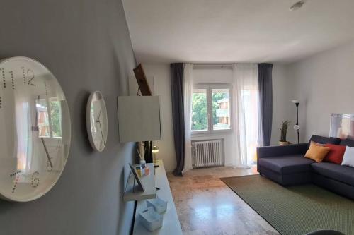 a living room with a blue couch and a mirror at FREE PARK Hapton house Big Mama - Easy to Venice in Mestre