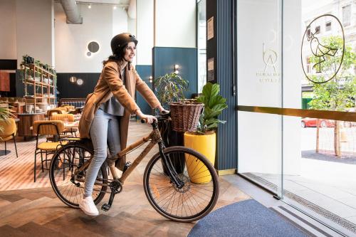 a woman riding a bike in a store at voco Auckland City Centre, an IHG Hotel in Auckland