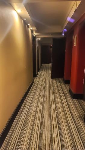 an empty hallway with a striped floor in a building at DEPARTAMENTO ESTUDIO (HOTEL PREMIUM TOWER SUITES) in San Luis