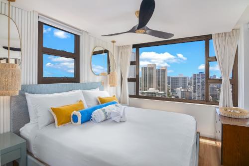 a bedroom with a bed with two stuffed animals on it at 30th Fl Luxury Ocean & Waikiki view with Free Parking in Honolulu