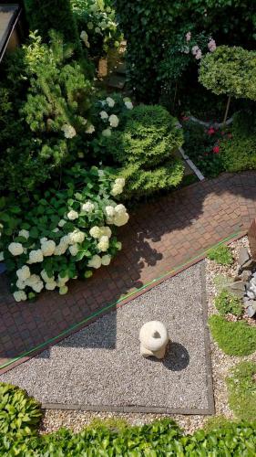 a garden with flowers and a stone bowl on the ground at Puszczykowska willa in Puszczykowo