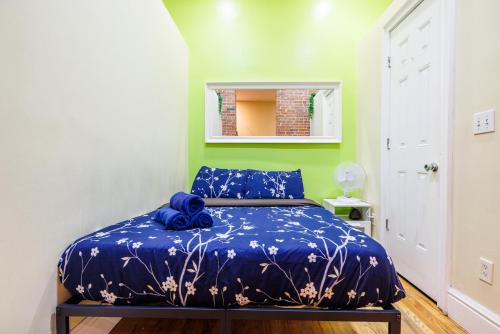 a bedroom with a bed with a blue blanket at Studios in New York in New York