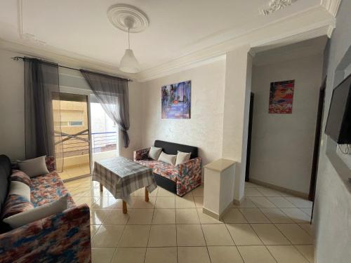 a living room with a couch and a table at Oasis by Azur spacieux proche de la plage in Oued Laou