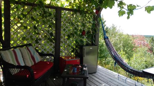 a gazebo with a hammock on a deck at The Eagle's Landing on Minamkeak Lake - A Serene Escape in Italy Cross