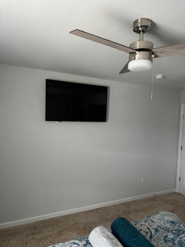 a living room with a flat screen tv on a white wall at QuickRoute Comfort Relax Living in McDonough