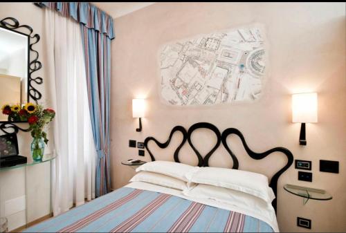 a bedroom with a bed and a map on the wall at Luxury Ripetta 2 in Rome