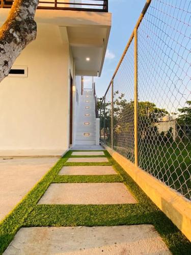 a walkway leading to a house with a fence at Casa Nefertari I in Flores