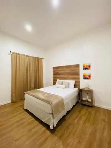 a bedroom with a large bed and a wooden floor at Casa Nefertari I in Flores