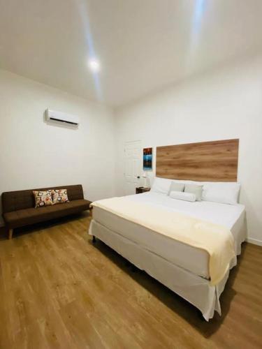 a bedroom with a large bed and a couch at Casa Nefertari I in Flores