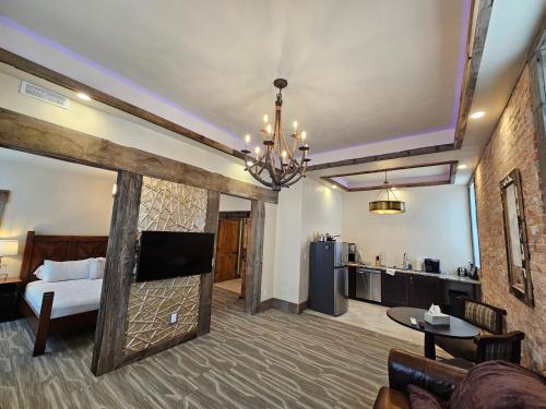 a living room with a bed and a kitchen at Eaglescape Suites and Event Center in Miles City