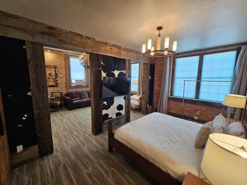 a bedroom with a bed with a cow wall at Eaglescape Suites and Event Center in Miles City