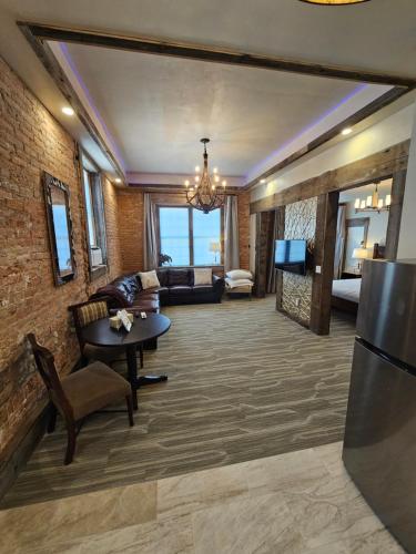 a living room with a couch and a table at Eaglescape Suites and Event Center in Miles City