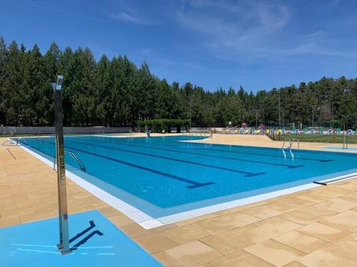 a large swimming pool with blue water at Casa dos Capitães Mores - Vila Flor in Vila Flor