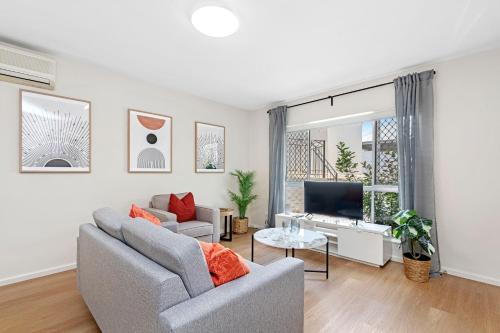 a living room with a couch and a tv at 4 Cute Cunningham Close To Subiaco - Sleeps 4 in Perth