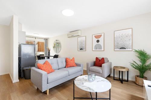 a living room with a couch and a table at 4 Cute Cunningham Close To Subiaco - Sleeps 4 in Perth