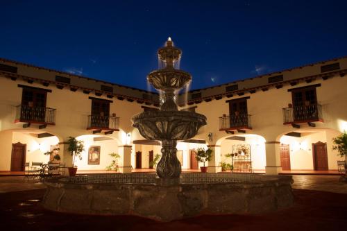 a fountain in front of a building at night at Hacienda Bajamar in Sonorabampo