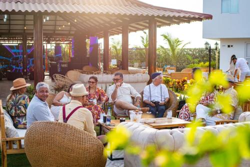 a group of people sitting at tables in a patio at Casa Bita Morales CASA 201 in Cartagena de Indias
