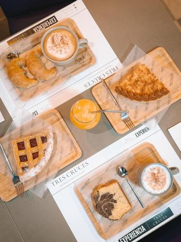 a table topped with different types of breakfast foods at Tres Cruces in Villa Unión
