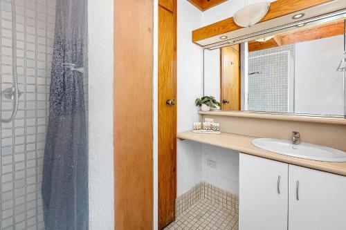 a bathroom with a shower and a sink at 8 Cottesloe Steps to beach - sleeps 3 in Perth