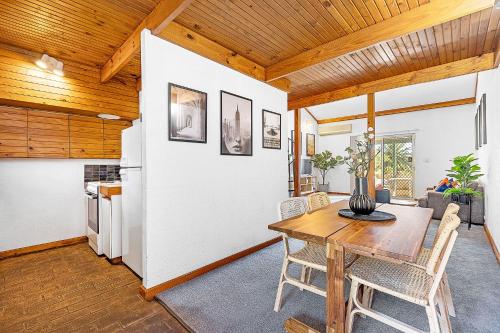 a kitchen and dining room with a wooden ceiling at 8 Cottesloe Steps to beach - sleeps 3 in Perth