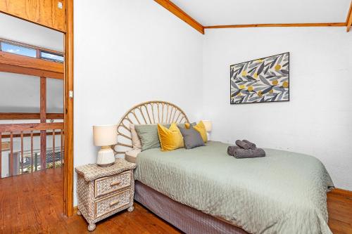 a bedroom with a bed and a table with a mirror at 8 Cottesloe Steps to beach - sleeps 3 in Perth