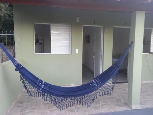 a blue hammock hanging in a room at POUSADA SÃO LUCAS in Águas de Lindóia