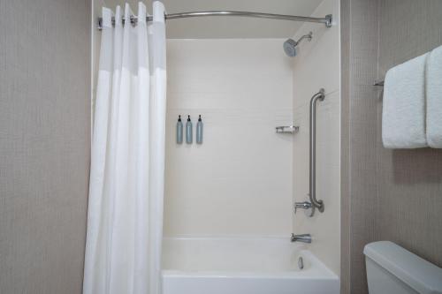 a bathroom with a shower with a white shower curtain at Residence Inn Washington, DC / Dupont Circle in Washington