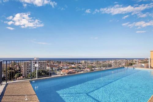a large swimming pool on top of a building at Bondi Beach Studio City Views and Balcony in Sydney