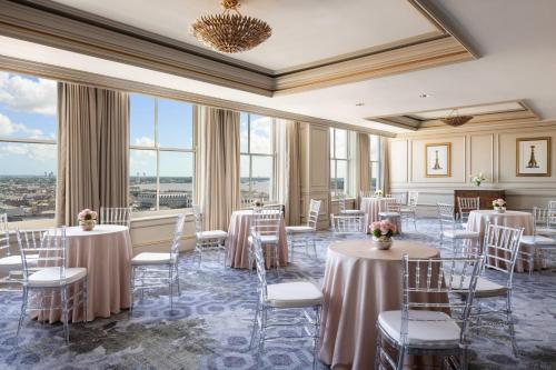 a banquet room with tables and chairs and windows at The Ritz-Carlton, New Orleans in New Orleans