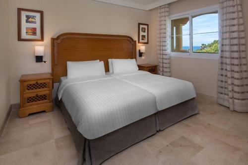 a bedroom with a large white bed and a window at Marriott's Marbella Beach Resort in Marbella