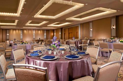 a banquet hall with tables and chairs with purple table cloth at The Westin Dallas Park Central in Dallas
