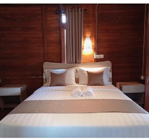 a bedroom with a bed with two towels on it at ADIKARA TROPICAL GARDEN in Gianyar