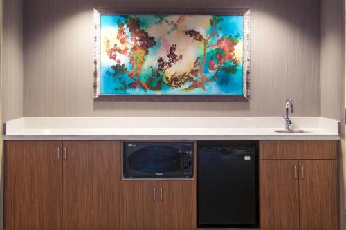 a kitchen with a sink and a microwave at Courtyard Palm Desert in Palm Desert