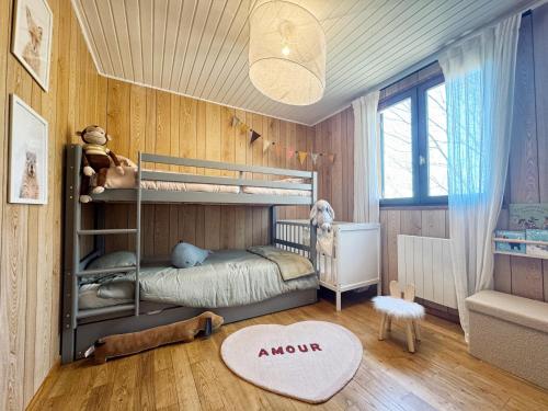 a childs bedroom with a bunk bed and a rug at Chalet de Dourbies in Dourbies