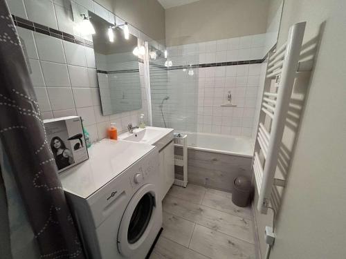 une salle de bain avec une machine à laver et un lavabo dans l'établissement Appartement Studio cabine, 4 couchages, face à la mer - FR-1-224C-304, à Saint-Jean-de-Monts