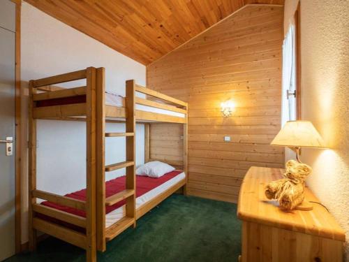 - une chambre avec 2 lits superposés et une table avec une lampe dans l'établissement Duplex cosy 3 pièces avec mezzanine, 2 salles de bain, balcon et casier à skis à Valmorel - FR-1-291-1008, à Valmorel
