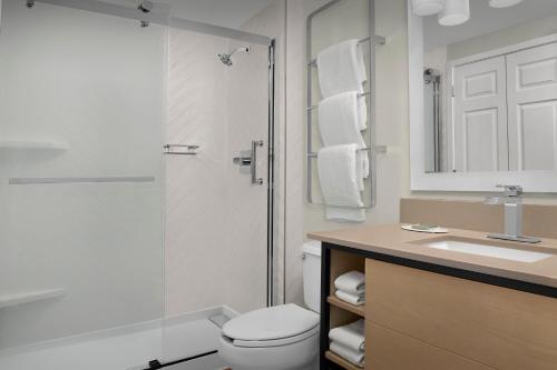a bathroom with a shower and a toilet and a sink at TownePlace Suites Sacramento Cal Expo in Sacramento