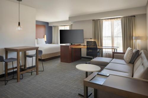 a hotel room with a couch and a bed at Residence Inn Phoenix Glendale/ Peoria in Peoria