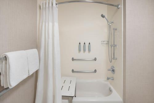 a white bathroom with a shower and a sink at Residence Inn Phoenix Glendale/ Peoria in Peoria