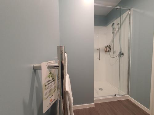 a shower in a bathroom with a glass shower stall at La Quinta by Wyndham Parnell Auckland in Auckland