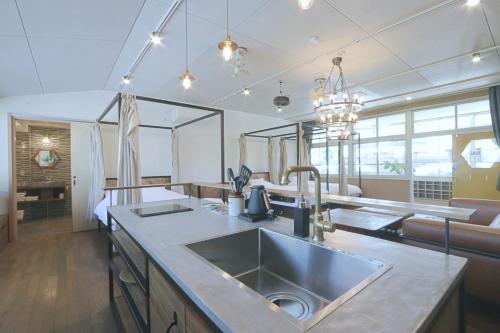 a kitchen with a sink and a counter top at TADONO the bedroom in Kanaya