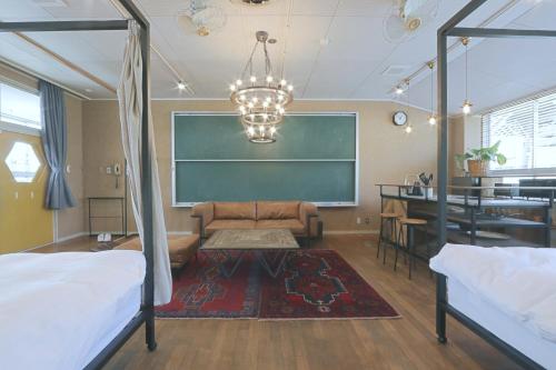 a room with a chalkboard and a bed and a classroom at TADONO the bedroom in Kanaya