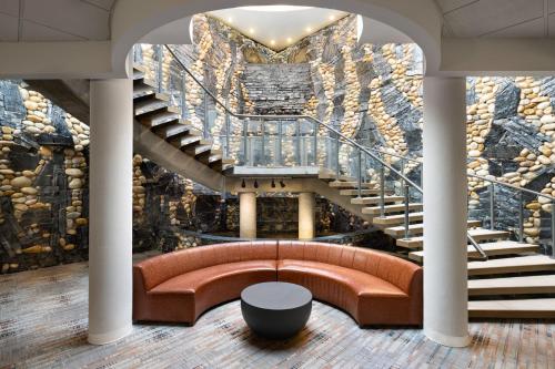 a lobby with a couch and a staircase at Four Points by Sheraton Edmonton South in Edmonton