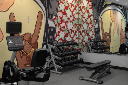 a gym with tread machines and a colorful wall at SpringHill Suites Houston Intercontinental Airport in Houston