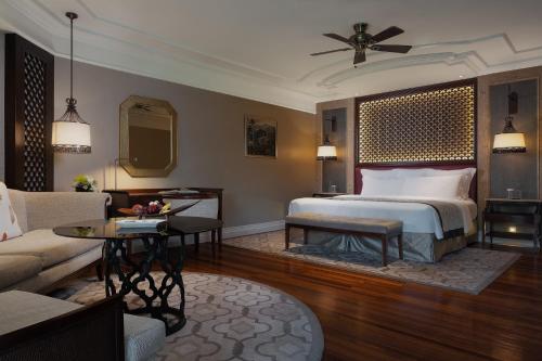 a bedroom with a bed and a living room at InterContinental Bali Resort by IHG in Jimbaran