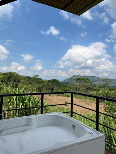 a bath tub on a balcony with a view at Romantic Glamping for 2 in the Mountain Access with 4x4 or motorbike only in Villeta