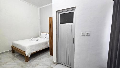 Ένα ή περισσότερα κρεβάτια σε δωμάτιο στο Umah Cenik